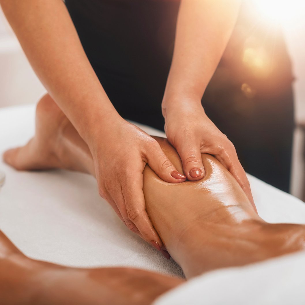 Anti Cellulite Massage. Masseuse Massaging a Female Calf